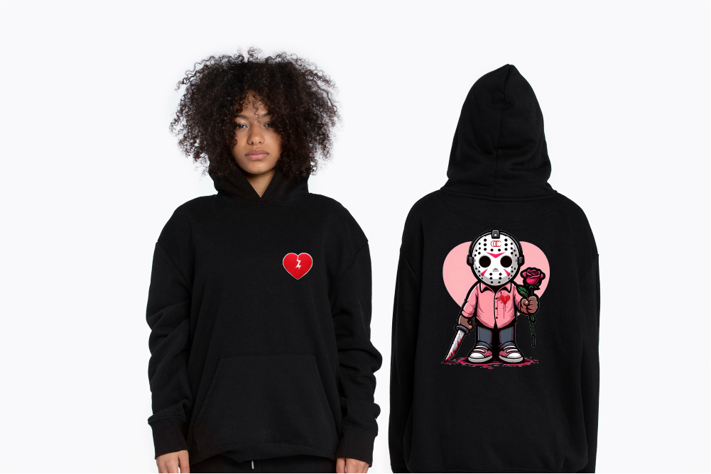 A hoodie with a heart and a broken heart pattern on the front and a graphic print of a character on the back, modeled by a person facing away from the camera.